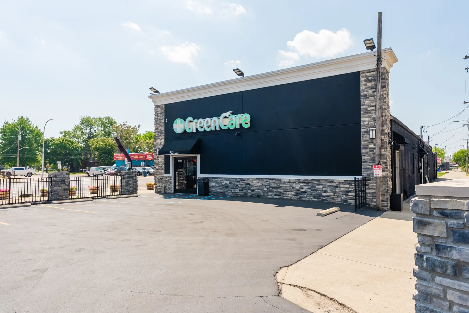 GreenCare storefront entrance and accessible parking area.