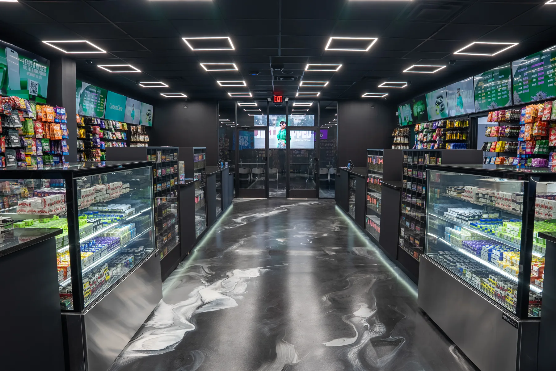 Inside GreenCare River Rouge with stocked cannabis display cases and illuminated shelves.
